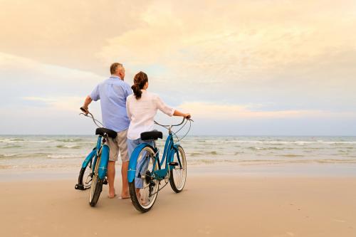 couple on beach with bikes