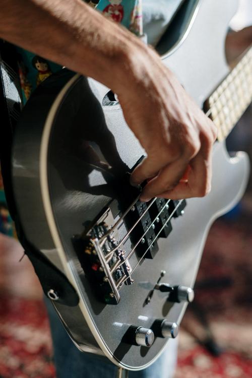 Hand playing electric guitar at a live music event